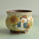 Ceramic pot with a decorative design of a duck and sunflower on a light green background