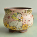 Ceramic cup with a duck design on a light green background