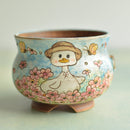 Ceramic pot with a cartoon duck design on a light background