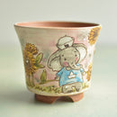 Ceramic cup with a cartoon elephant design on a light background