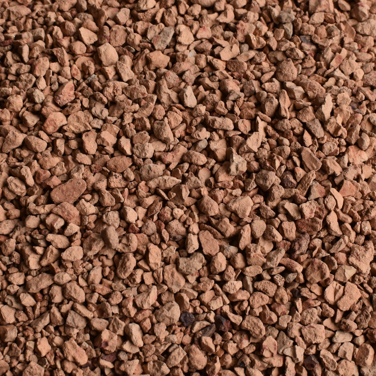 Container of calcined clay top dressing on a gray background