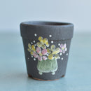 Small Black Handmade Ceramic Succulent Pot with Pink and Yellow Flowers in Pot Approximately 2"